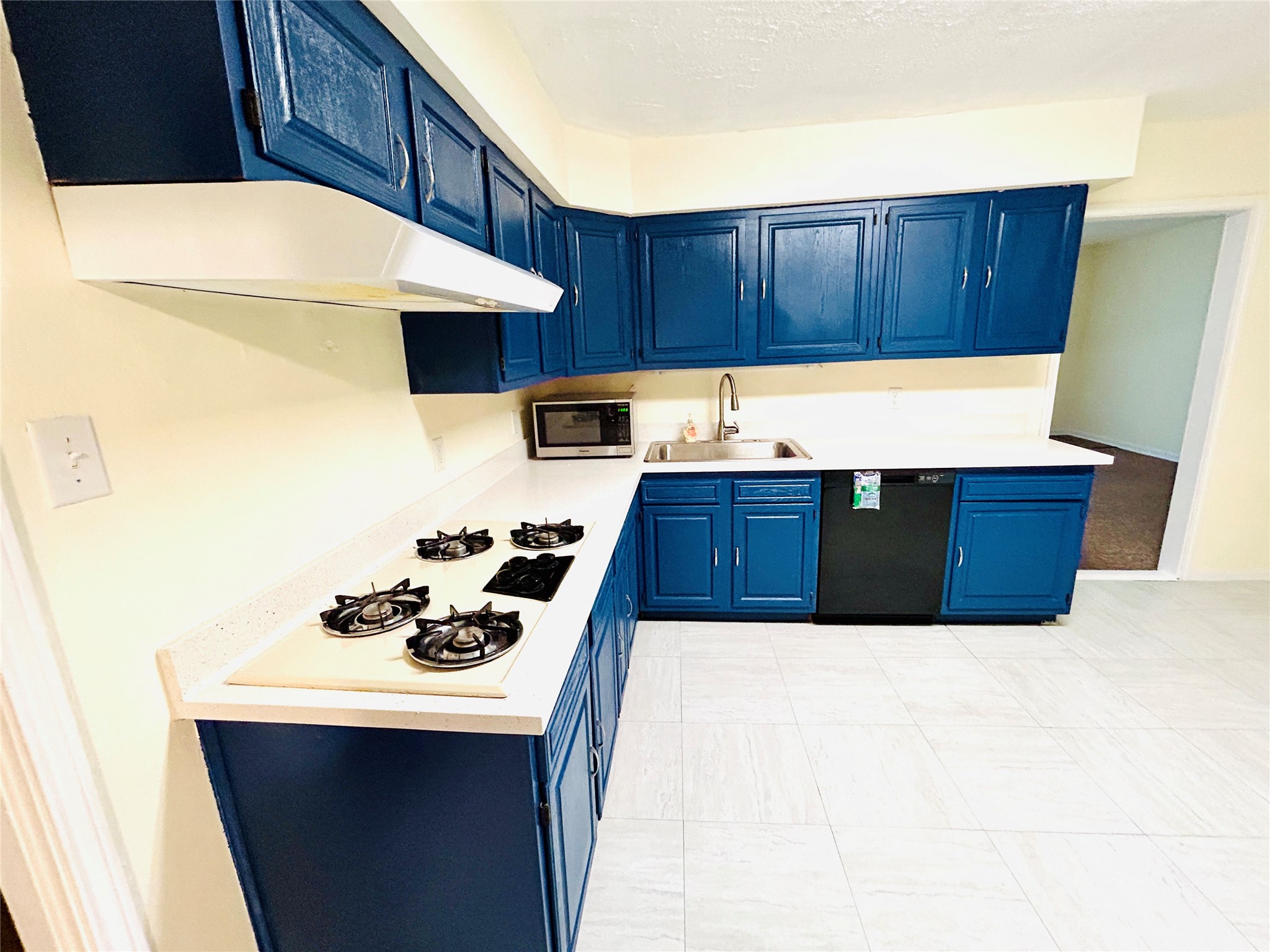 5806 Beldart Street Houston, TX 77033 - Photo 9 of 23 a kitchen with a cabinets and wooden floor