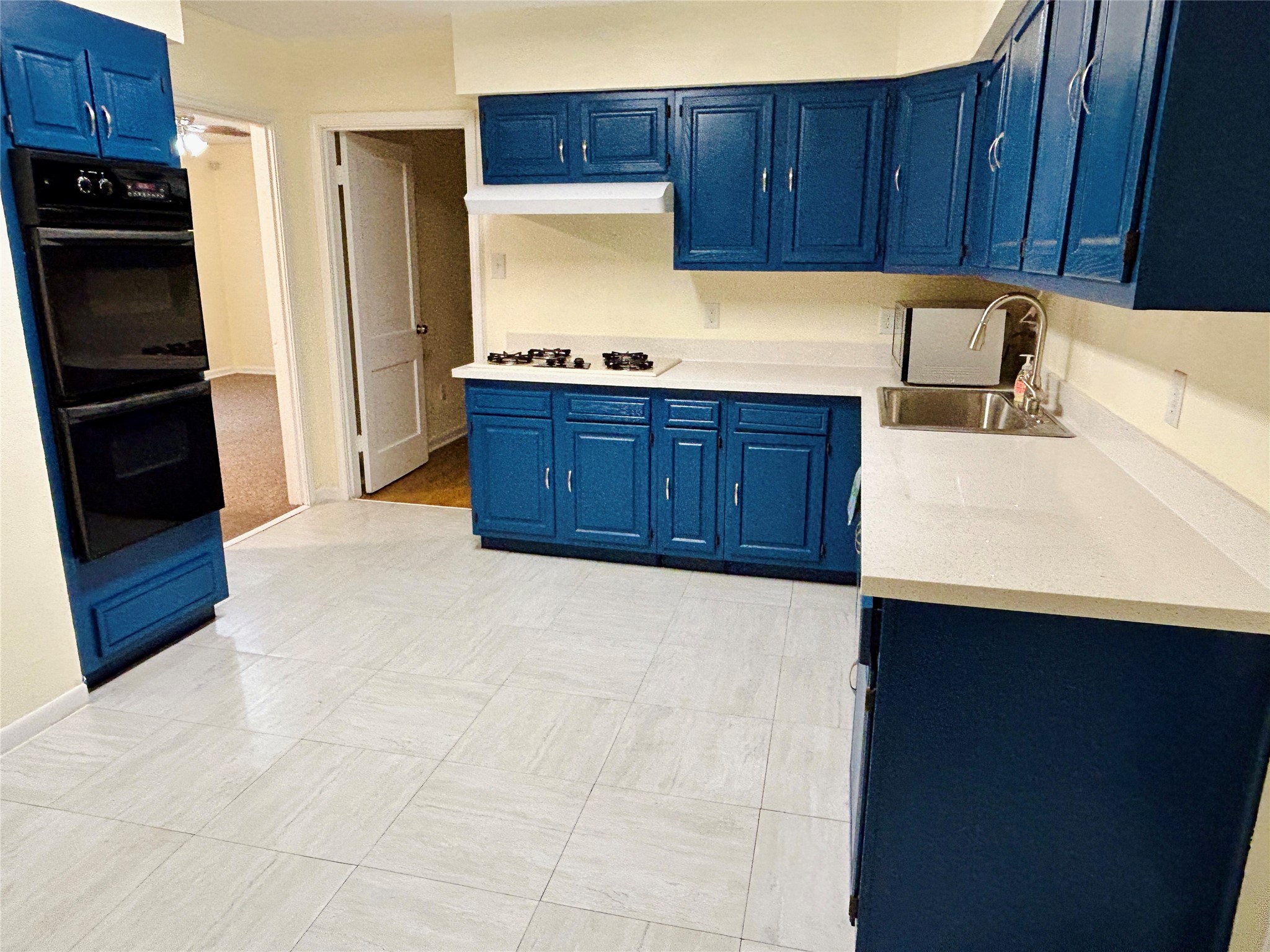5806 Beldart Street Houston, TX 77033 - Photo 10 of 23 a kitchen with a refrigerator and a sink