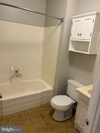 a bathroom with a toilet and a bathtub