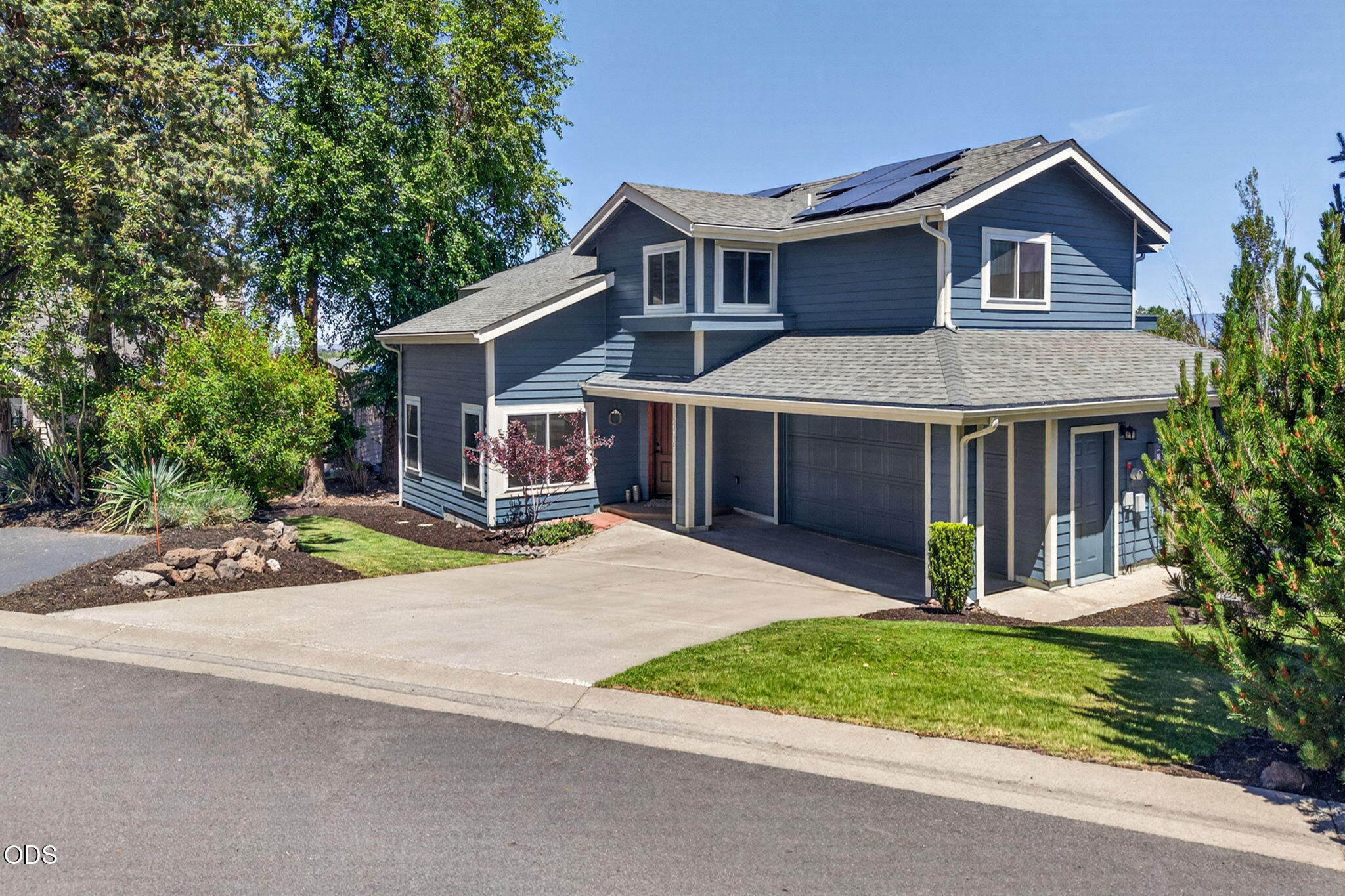 2486 Southwest Valleyview Drive Redmond, OR 97756 - Photo 5 of 55 a front view of a house with a yard and garage