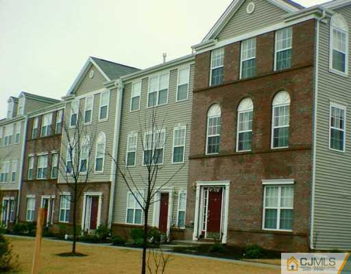 a front view of a residential apartment building with a yard