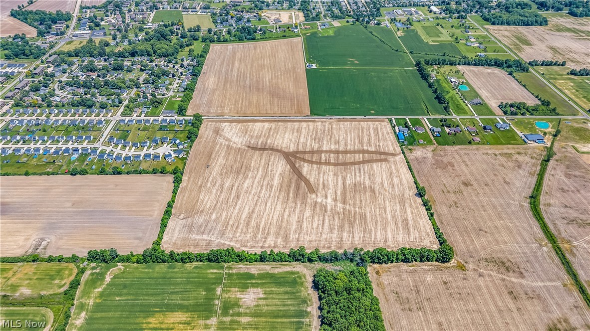 Expansive aerial view of a large agricultural parcel featuring tilled earth
