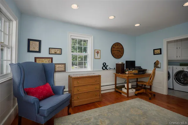 a living room with furniture a rug and a window