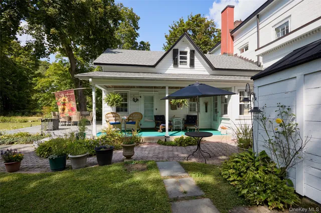 a front view of a house with a yard table and chairs