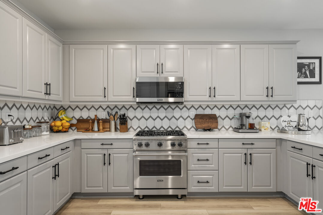 756 Daniel Freeman Circle Inglewood, CA 90301 - Photo 13 of 54 a kitchen with white cabinets and appliances