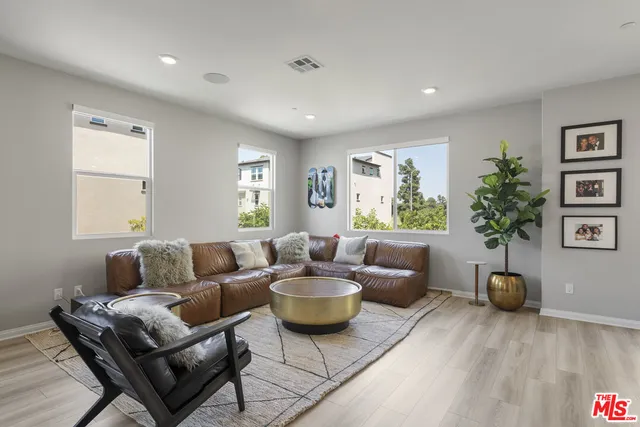 a living room with furniture and a potted plant
