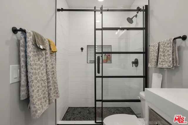 a bathroom with a shower toilet and a sink
