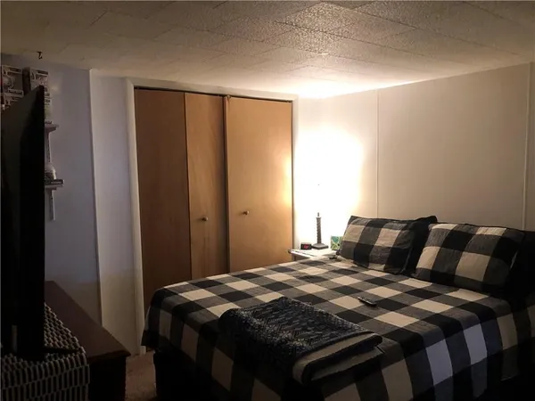 a bedroom with a bed and a mirror