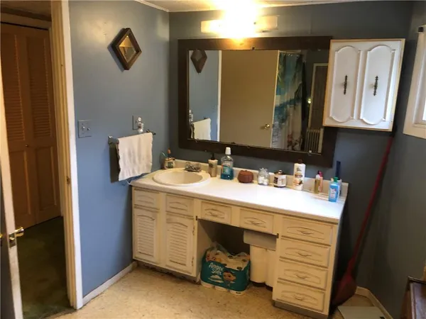 a bathroom with a sink vanity and mirror