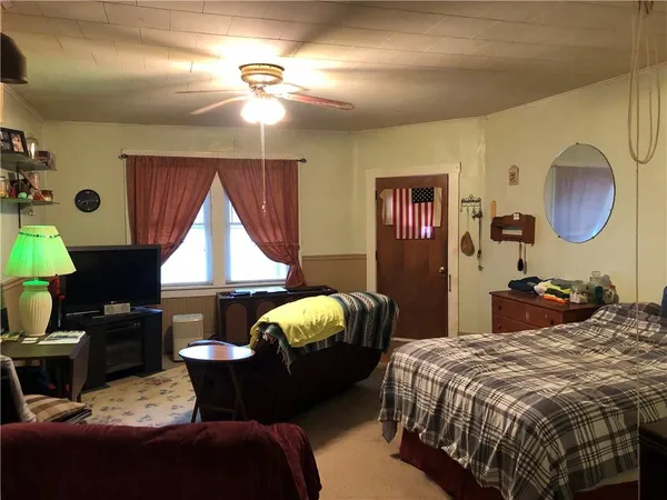 a bedroom with bed and a window