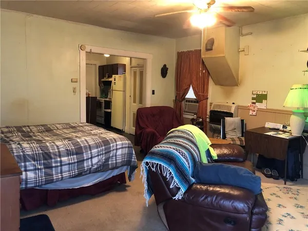 a bedroom with a bed couch and window