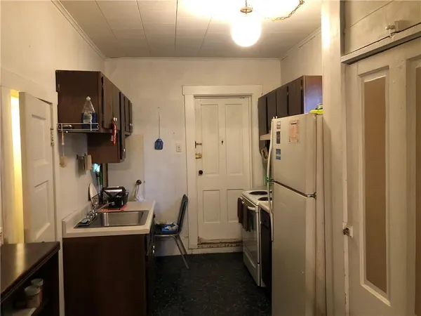 a kitchen with stainless steel appliances a refrigerator and a sink
