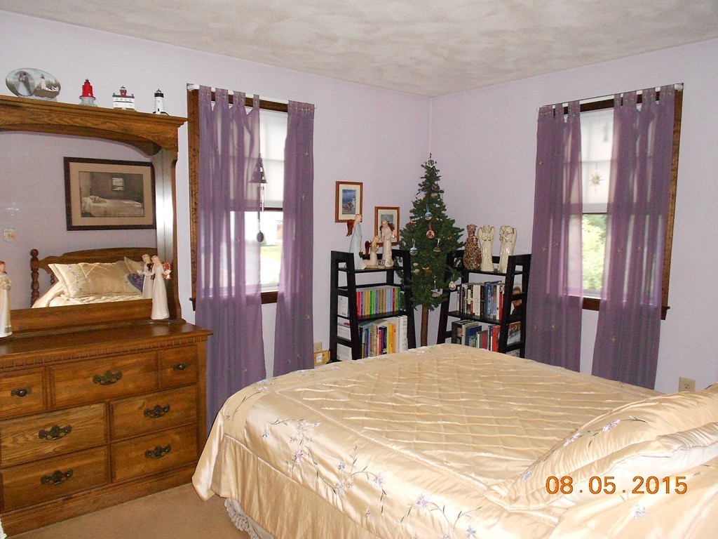 10 Virgo Lane Townsend, MA 01469 - Photo 11 of 14 a bed sitting in a bedroom and a mirror