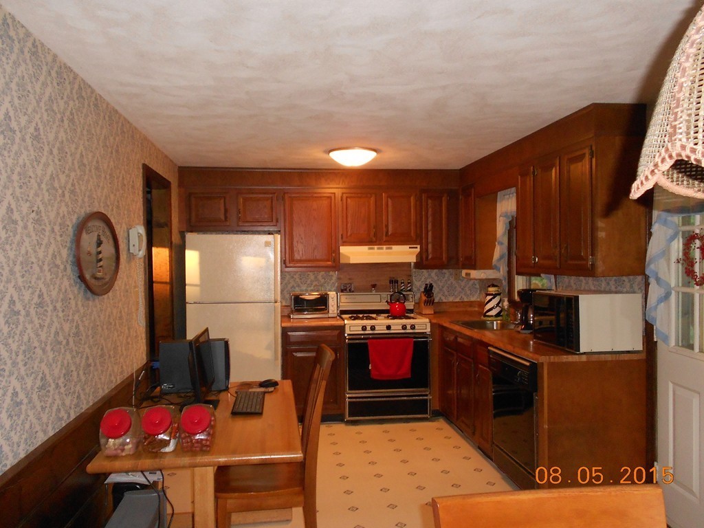 10 Virgo Lane Townsend, MA 01469 - Photo 5 of 14 a kitchen with granite countertop a refrigerator stove and sink