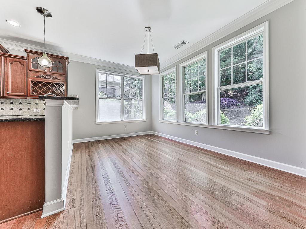 626 Laurel Crossing Canton, GA 30114 - Photo 20 of 77 a view of an empty room with a window and wooden floor