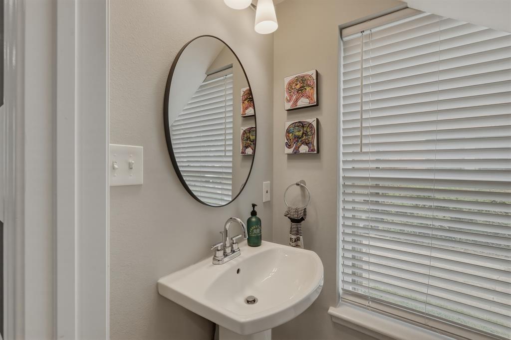 5914 Goodwin Avenue Dallas, TX 75206 - Photo 11 of 32 a bathroom with a sink and a mirror