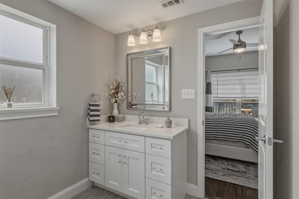5914 Goodwin Avenue Dallas, TX 75206 - Photo 13 of 32 a bathroom with a sink and a mirror