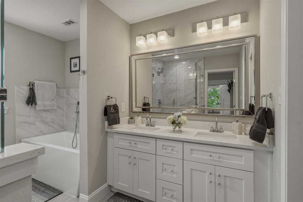 5914 Goodwin Avenue Dallas, TX 75206 - Photo 16 of 32 a bathroom with a double vanity sink mirror and bathtub