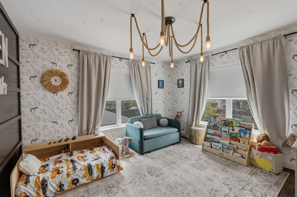 5914 Goodwin Avenue Dallas, TX 75206 - Photo 24 of 32 a bedroom with furniture and a wooden floor