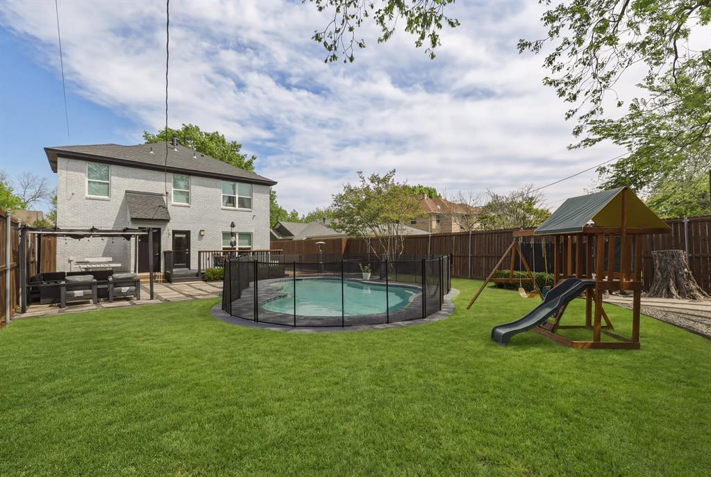 5914 Goodwin Avenue Dallas, TX 75206 - Photo 28 of 32 a swimming pool with lots of tress in front of it