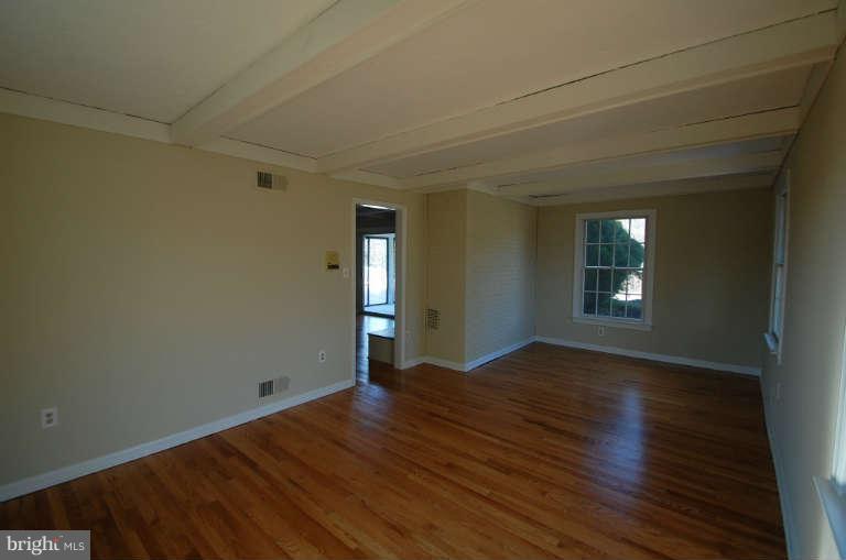 1904 Ednor Road Silver Spring, MD 20905 - Photo 11 of 30 a view of empty room with wooden floor and fan