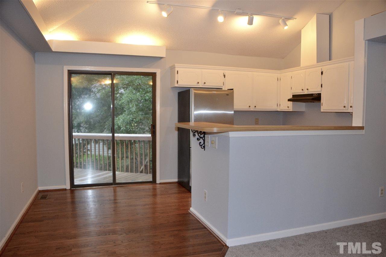 3500 Mill Run Raleigh, NC 27612 - Photo 6 of 8 an empty room with wooden floor and windows