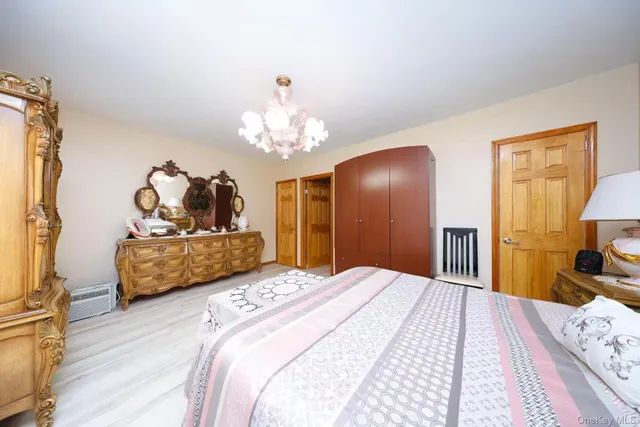 a bedroom with a bed and a chandelier