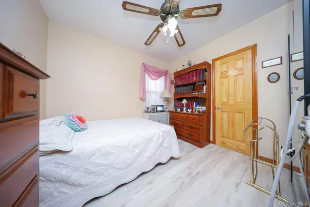 a bedroom with a bed and a bookshelf