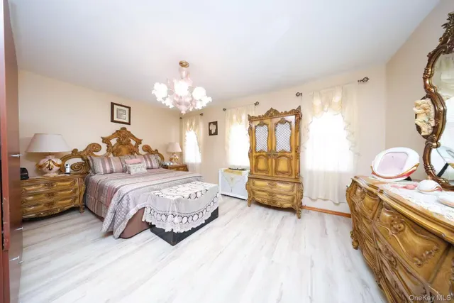 a bedroom with a bed and a chandelier