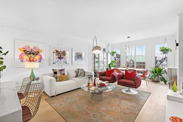 a living room with furniture or couch and a potted plant