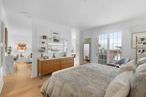 a bed room with a bed and a large window