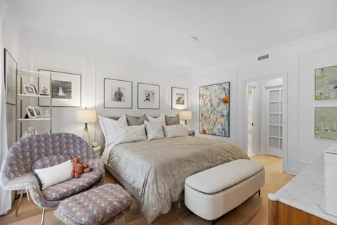 a spacious bedroom with a bed and a couch