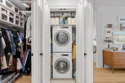 a view of walk in closet with clothes and shoes