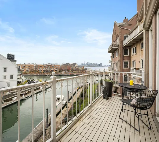a view of a balcony with wooden floor and seating space