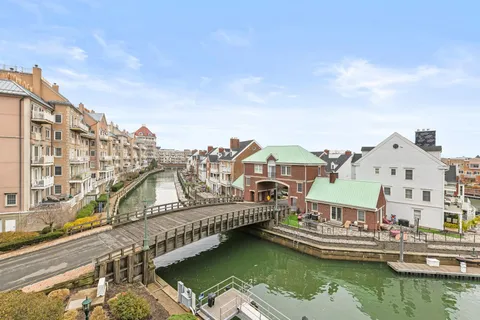 a view of building with yard and large trees