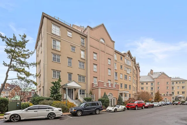 a couple of cars parked in front of a building