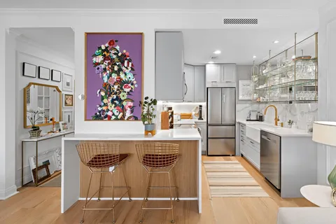 a kitchen with stainless steel appliances granite countertop a sink and a refrigerator