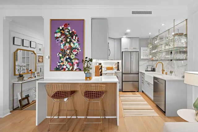 a kitchen with stainless steel appliances granite countertop a sink and a refrigerator