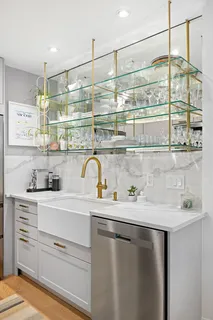 a kitchen with stainless steel appliances a sink and cabinets