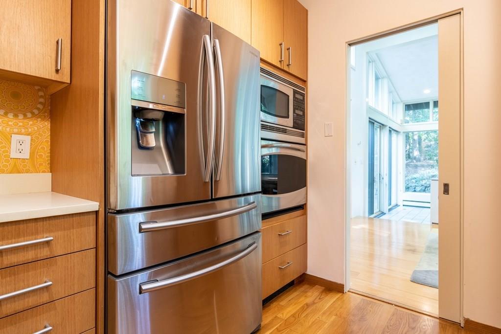 28 Peacock Farm Road Lexington, MA 02421 - Photo 14 of 29 a kitchen with stainless steel appliances and wooden floor