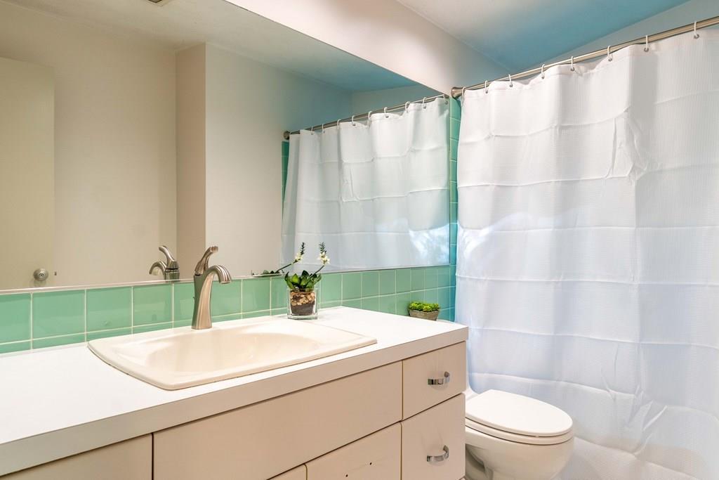 28 Peacock Farm Road Lexington, MA 02421 - Photo 25 of 29 a bathroom with a sink and a mirror