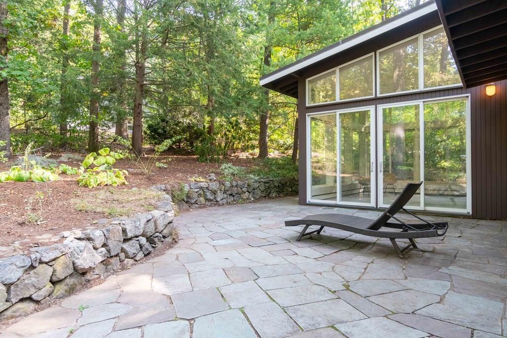 28 Peacock Farm Road Lexington, MA 02421 - Photo 29 of 29 a view of a house with backyard porch and sitting area