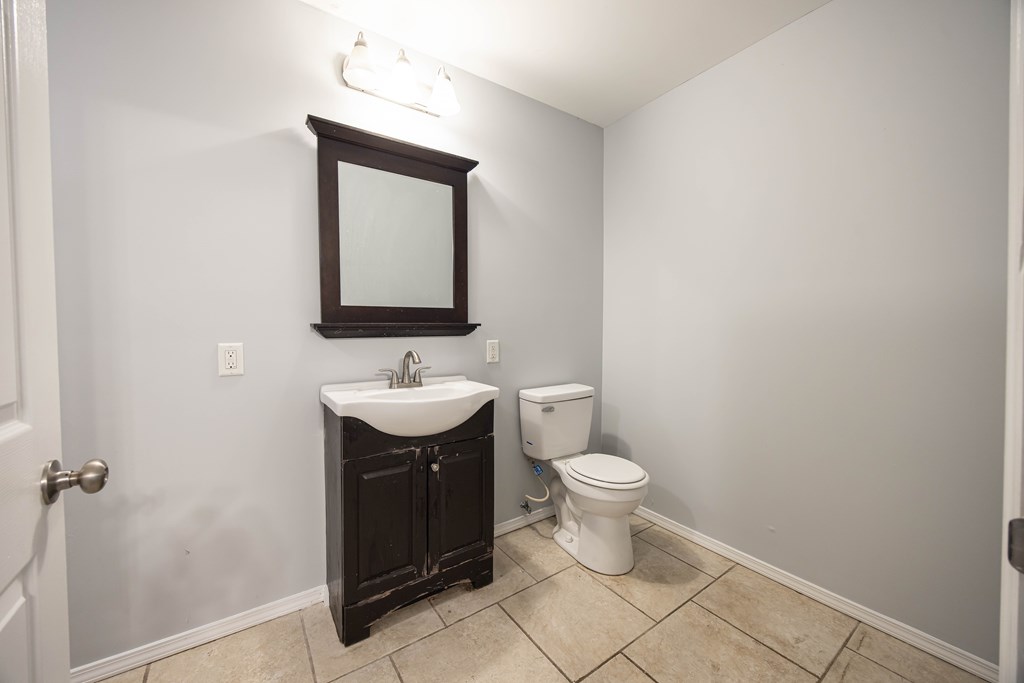 2113 Summerville Road Phenix City, AL 36867 - Photo 22 of 37 a bathroom with a toilet sink and mirror