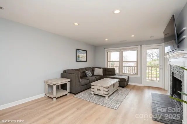 a living room with furniture flat screen tv and a fireplace