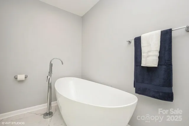 a white bath tub sitting in a bathroom