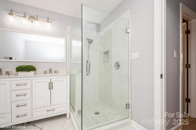 a bathroom with a shower sink and mirror