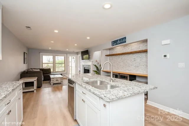 a kitchen with stainless steel appliances granite countertop a sink stove and cabinets