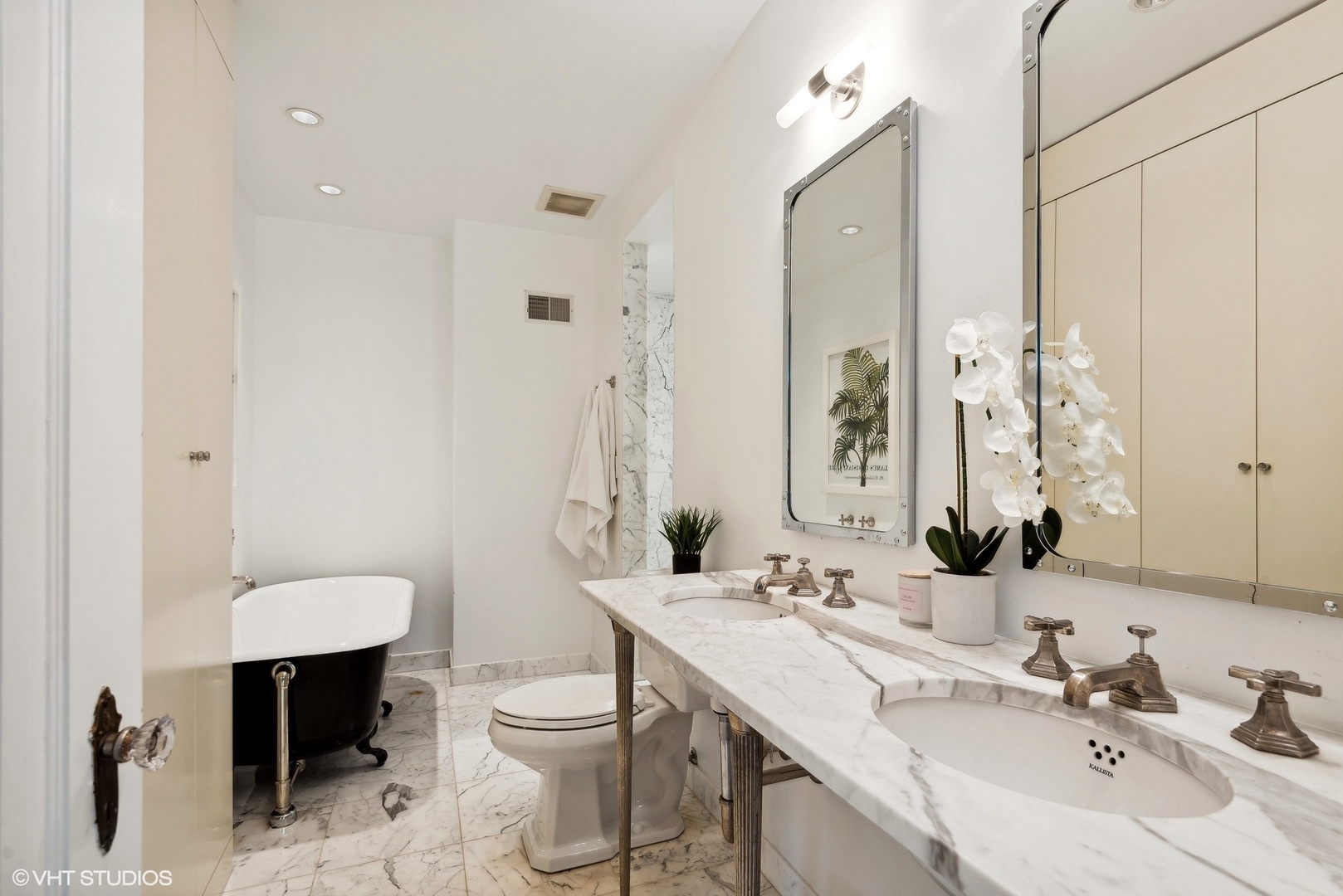 1701 Forest Avenue Wilmette, IL 60091 - Photo 20 of 35 a bathroom with a double vanity sink toilet and mirror