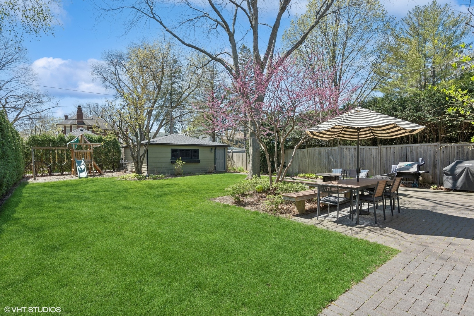 1701 Forest Avenue Wilmette, IL 60091 - Photo 31 of 35 a patio with a table and chairs under an umbrella