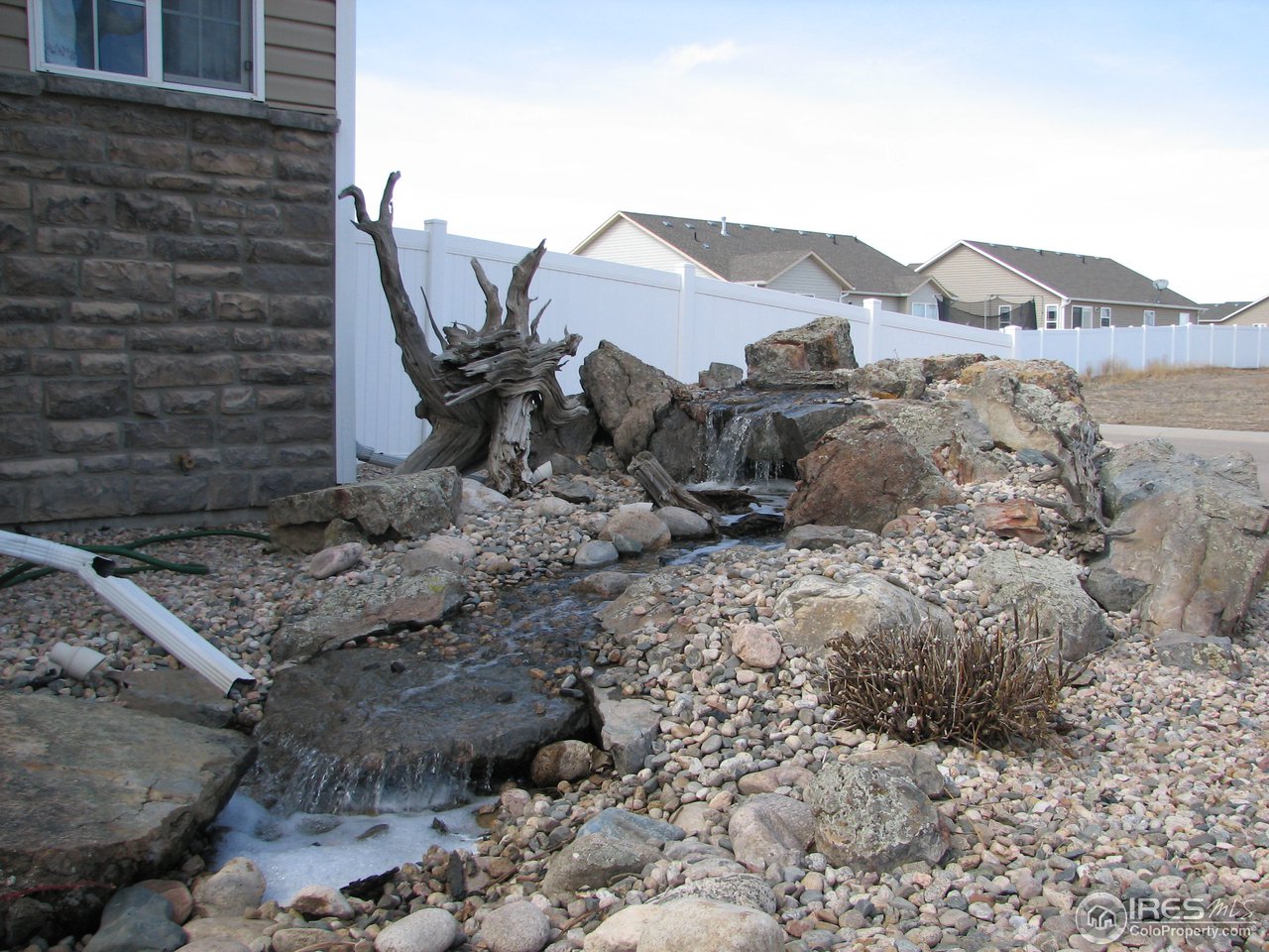6887 McClellan Road Wellington, CO 80549 - Photo 3 of 25 Outstanding landscaping including this lovely wate